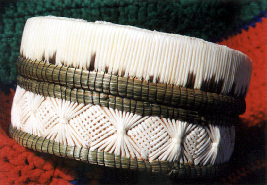 This closeup photo of Lillian's Crafts quillboxes shows the intricate weaving of the porcupine quills and sweetgrass binding.